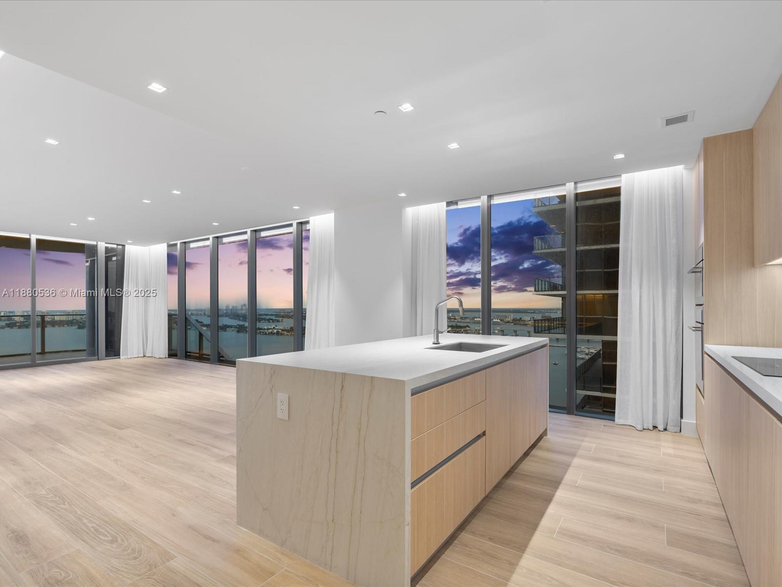 The premier line in Aria Reserve’s South Tower— with $250K in improvements for an unmatched living experience. This 2,500+ SF corner residence includes 2 assigned parking spots and features a private elevator foyer, 4 bedrooms, 5.5 baths + den, oak-style tile, chef’s kitchen with Thermador appliances & waterfall island, illuminated primary closet, recessed drop ceilings, and electric curtains with blackouts. A 298 SF terrace frames panoramic views of Miami's most iconic landscape. Resort style living with 2 acres of world-class amenities: resort pools, spa with sauna & massage rooms, fitness & wellness centers, kids’ club, putting green, plus tennis, basketball & pickleball. Prime Edgewater location—steps to Design District and minutes to Brickell & the beaches.
