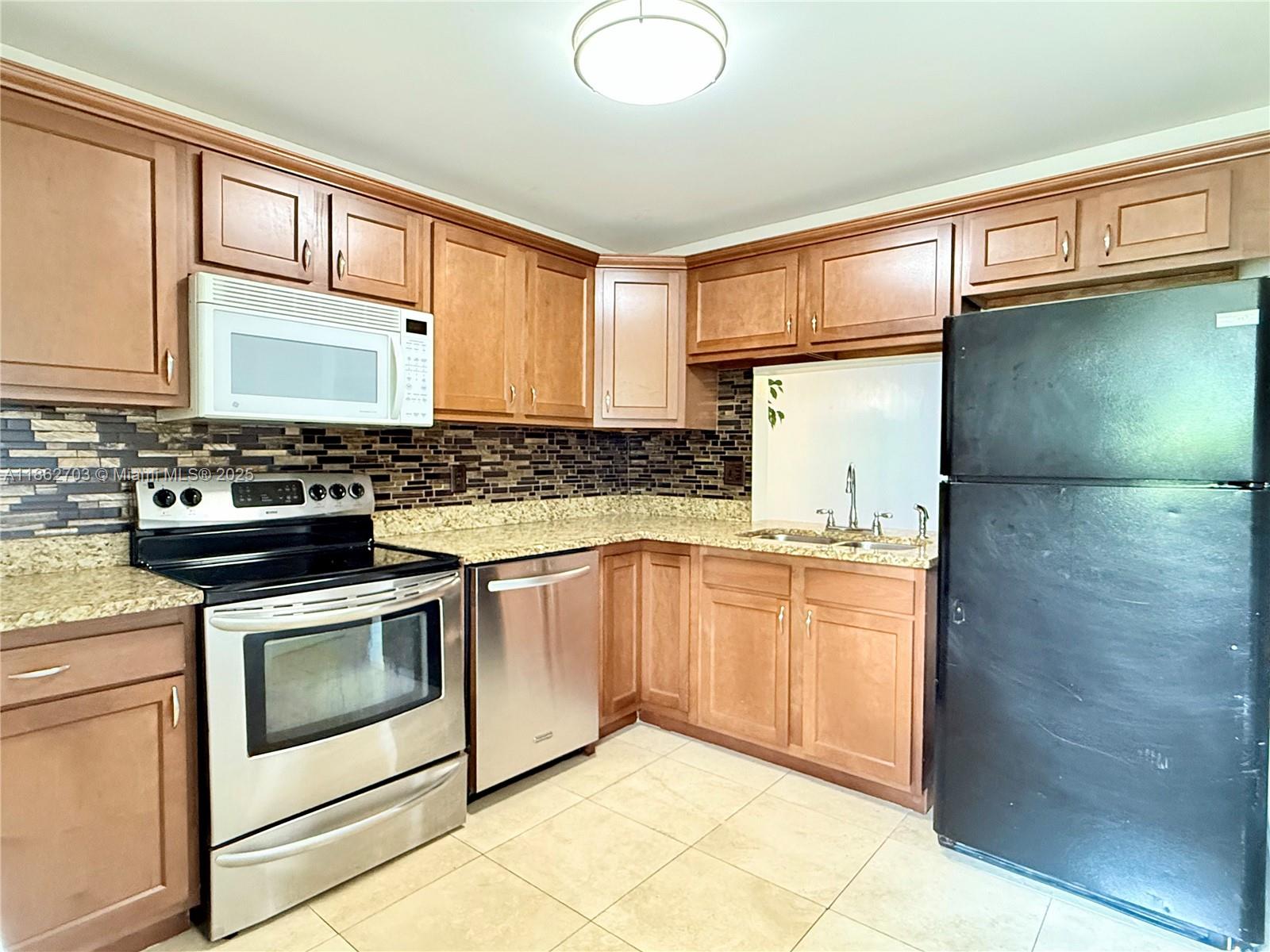 DISCOVER THIS BEAUTIFUL & OVERSIZED 1 BEDROOM 1 BATH PLUS DEN CONDO LOCATED ON THE 1st FLOOR OF THE GATED BERKELEY MANOR COMMUNITY IN PLANTATION. ENJOY PEACEFUL LAKE VIEWS & NATURAL LIGHT FROM THIS CORNER UNIT WITH A LARGE FLEX SPACE WITH ROOM TO CREATE A 2nd BEDROOM & BATH. THE UPDATED KITCHEN FEATURES GRANITE COUNTERS & BEAUTIFUL WOOD CABINETS. TILE FLOORING THROUGHOUT & LAMINATE IN THE ROOM. THE COMMUNITY OFFERS 3 POOLS, CLUBHOUSE, BBQ AREA, STORAGE, LAUNDRY ROOMS AND GATED ENTRY. HOA COVERS WATER, SEWER, TRASH, ROOF & BUILDING INSURANCE. ONE ASSIGNED PARKING SPACE PLUS AMPLE GUEST PARKING. IDEALLY LOCATED NEAR SHOPS, RESTAURANTS, PARKS, HOLLYWOOD BEACH, TURNPIKE AND MAJOR ROADS. QUIET YET CENTRALLY LOCATED. ALL AGES WELCOME. NO PETS ALLOWED. MOTIVATED SELLER! NO RENTAL RESTRICTION