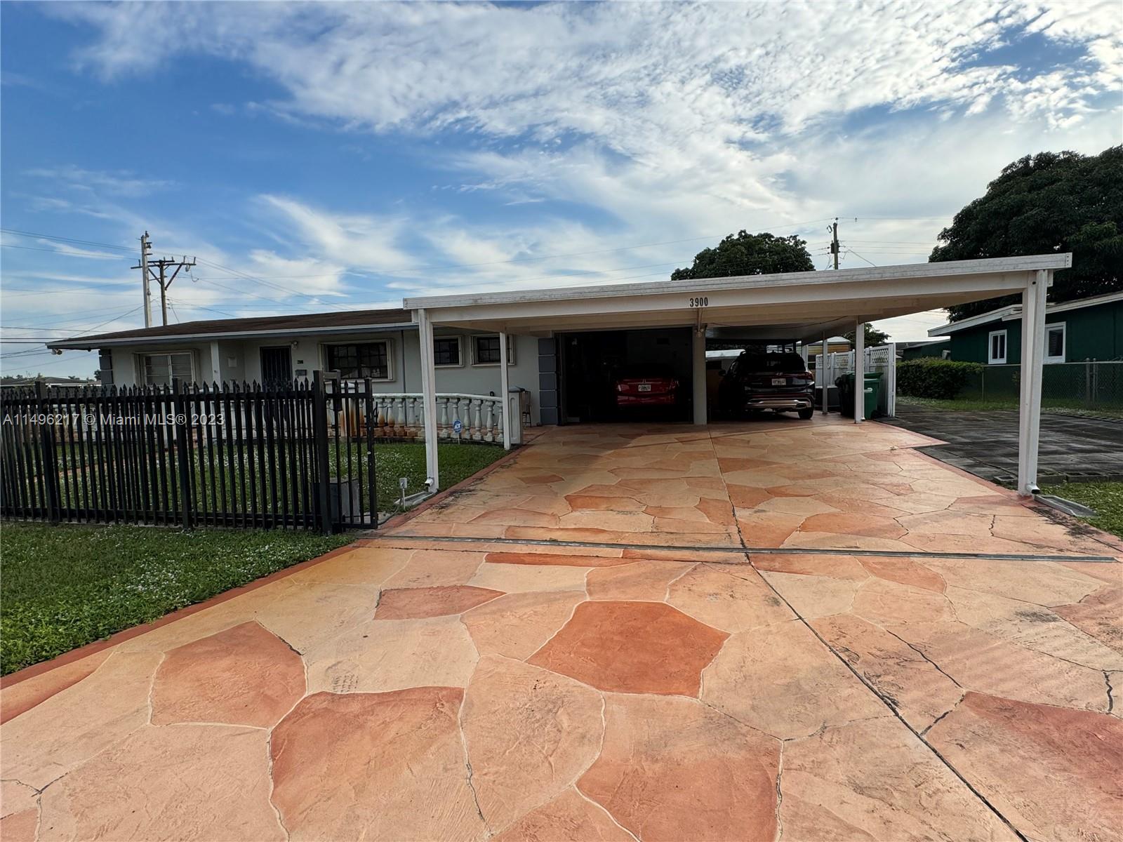 Buyer Financing fell through! This is a must-see! Huge fenced corner lot with a beautiful covered driveway in the sought-after area of Miami Gardens. It has amazing curb appeal. This 3 bedroom 1.5 half bathroom property is a perfect family house ready for the new owner to come a put its special touch to make it home. Close to the shopping, restaurants, Hardrock stadium and so much more. Open House Sat 1/27/24 1-3pm