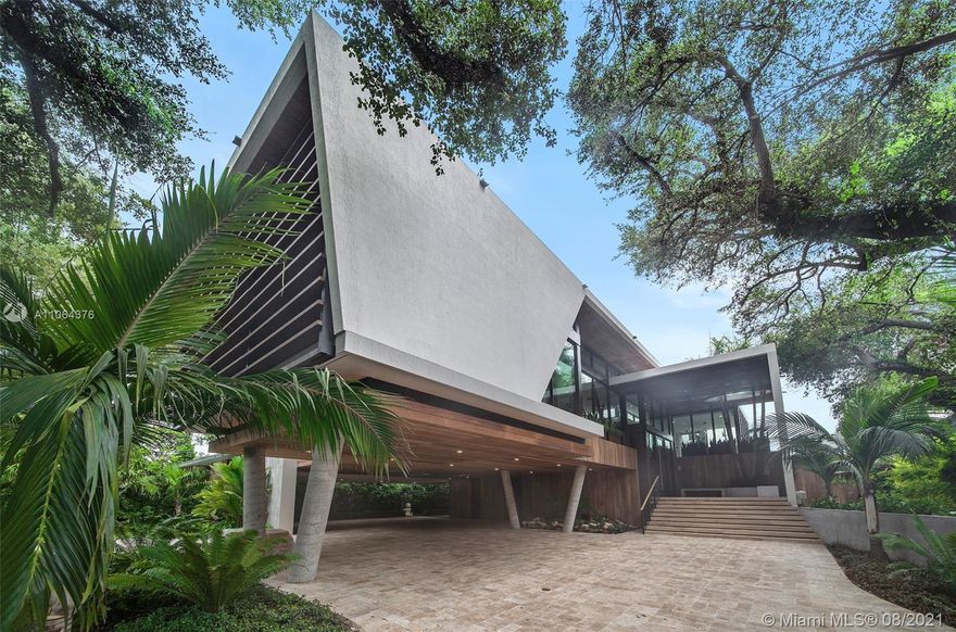 Spectacular Tropical Modern masterpiece set within a lush botanical garden behind a custom coral rock garden and gate. Designed by acclaimed architect Gabriel Lopez. The quality of finishes, fixtures, and attention to detail is unsurpassed by any new construction home in Coconut Grove. Double-height ceilings and walls of glass create a seamless blending of interior and fabulous exterior spaces. Custom kitchen by Bontempo. Smart Home automation. 2-electric car charging stations. 24/7 security patrol. Live amongst the elite on the exclusive residences behind Vizcaya Gardens. Minutes to downtown, Brickell, and the Beaches. Total 16,304 SF; Adj 9,753 SF