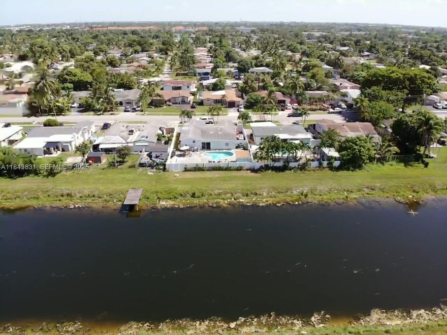 INCOME PROPERTY!!!  FEATURES A RENOVATED KITCHEN , UPDATED FLOORS AND DOORS. CALIFORNIA CLOSETS A SALTWATER POOL, AND A BACKYARD WITH CANAL ACCESS- PERFECT FOR JET SKI. INCLUDES A WATER PUMP SYSTEM THAT DRAWS WATER FROM THE CANAL TO IRRIGATE THE LAWN TROUGH THE SPRINKLERS.  EASY TO SHOW.