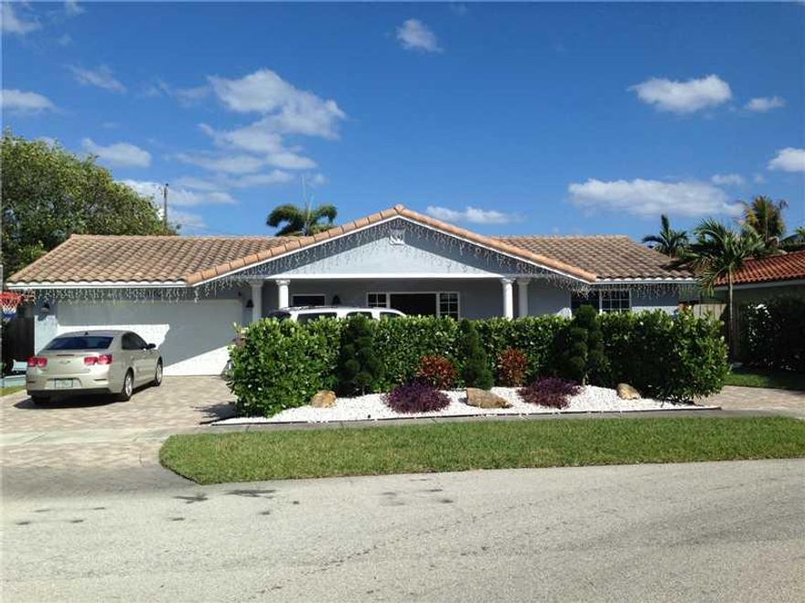 Ready to move in! Easy showings. House completely renovated, walnut wood floor in entire house, renovated bathrooms and Kitchen.  New impact doors and windows and hurricane garage door.  Nice landscaping and 12 ft high healthy ficus hedge in back yard for  privacy. Crown molding throughout house. Master bath has shower and jacuzzi tub.