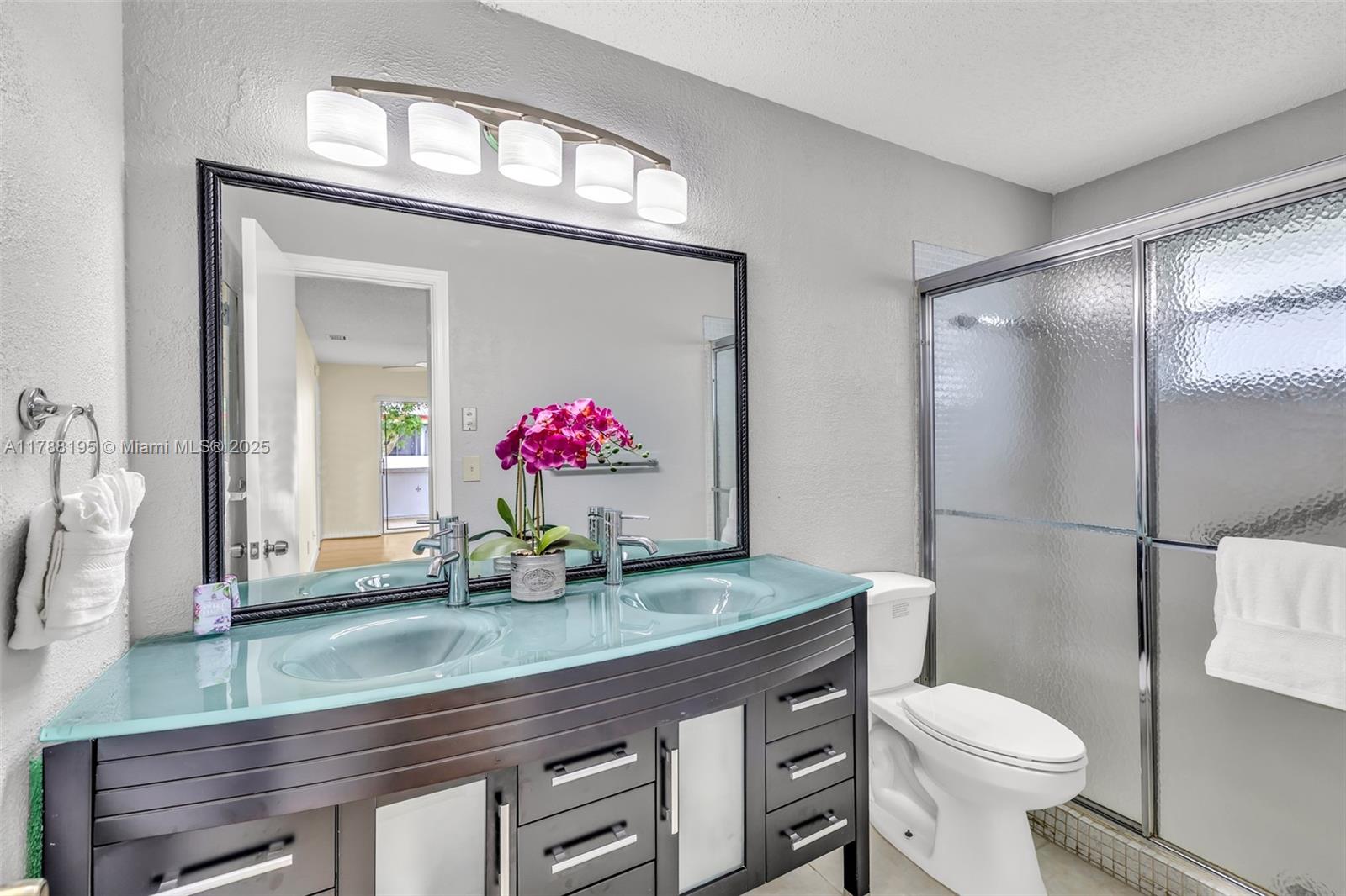 Discover the perfect blend of comfort and convenience in this spacious 2-bed, 2-bath single-family home with a 1-car garage and double-wide driveway, nestled in the desirable 55+ community of Lauderdale West. Enjoy a split bedroom layout, walk-in closet, and an updated kitchen with stainless steel appliances, generous counter space, and ample cabinetry. Vinyl flooring in bedrooms and tile throughout the main areas make upkeep a breeze. A versatile multipurpose room and large screened-in patio offer great space for relaxing or entertaining. The low HOA covers roof repair/replacement, lawn, cable, internet, and access to fantastic amenities—two pools, clubhouse, fitness center, tennis, shuffleboard, billiards, social events, and a courtesy bus. Resort-style living just steps from your door!
