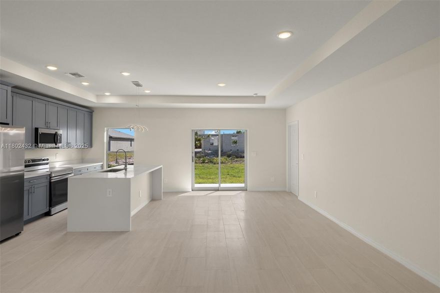 PRICED TO SELL. Discover the perfect blend of style, comfort, and convenience in this stunning Move-In Ready new construction featuring 3 beds, 2 baths, and a spacious open floor plan that offers modern living at its best. Enjoy premium upgrades such as tile flooring throughout, deluxe waterfall kitchen island, stainless steel appliances, soft shaker cabinets, and elegant quartz countertops. The Master Suite boasts his & hers walk-in closets, dual vanities, and a luxurious walk-in shower. Impact windows and doors for added security and energy efficiency, a double-car garage, and a built-in sprinkler system. The automatic irrigation system ensures your lawn stays lush and green all year round. Plus, the washer and dryer are included, making this home truly move-in ready.