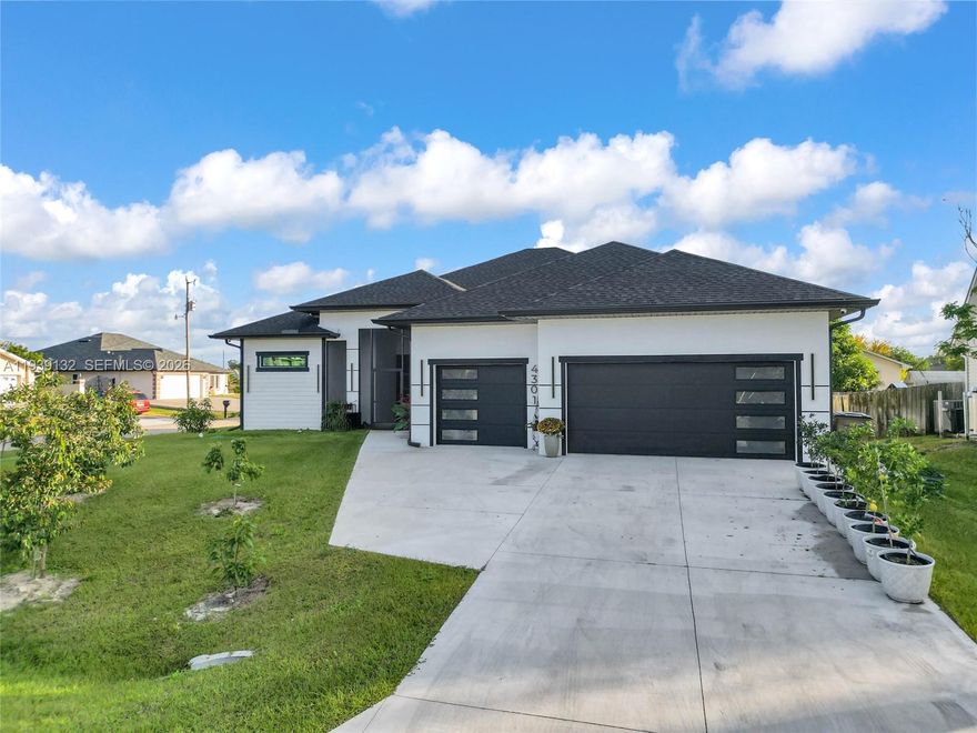 4,105 SQFT Home on Corner Lot! Centrally located just minutes from schools, hospitals, shopping, and entertainment, this stunning move-in-ready home offers luxury, space, and convenience. Featuring 4 bedrooms plus a den and 4 bathrooms, no detail has been overlooked. The home welcomes you with manicured landscaping, 8-ft impact French doors, impact windows throughout, 10-ft tray ceilings, and imported 24” x 48” porcelain tile floors. The chef’s kitchen boasts an oversized quartz waterfall island, quartz backsplash, premium KitchenAid stainless steel appliances, double wall ovens, French-door refrigerator, and a large pantry. The expansive primary suite includes his-and-hers walk-in closets and a spa-style bathroom with double quartz vanities, backlit defog mirrors, jetted tub, and multi-head shower. A large den offers flexibility as an office or optional 5th bedroom. Enjoy the fully equipped outdoor kitchen, perfect for entertaining, and a triple-car garage with epoxy floors. Additional highlights include a stem wall foundation, second driveway for RV or boat parking, and a lush yard with mango, avocado, guava, banana, longan, and star apple trees. Furniture is negotiable. Easy to show—this exceptional home won’t last long!