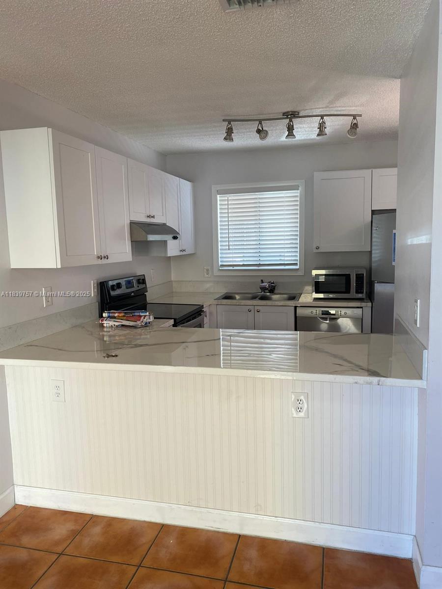 Remodeled and spacious (1,220 sq ft ) 3/2 condo in Paseo Real (two stories). Remodeled kitchen with white wood cabinets, epoxy counter tops, Carrara marble backsplash & stainless steel appliances. Bathrooms have been updated. Full size washer & dryer in unit. Pool views from the unit. 2 assigned parking spaces. The condominium has a security patrol and pool. Pets not allowed.
