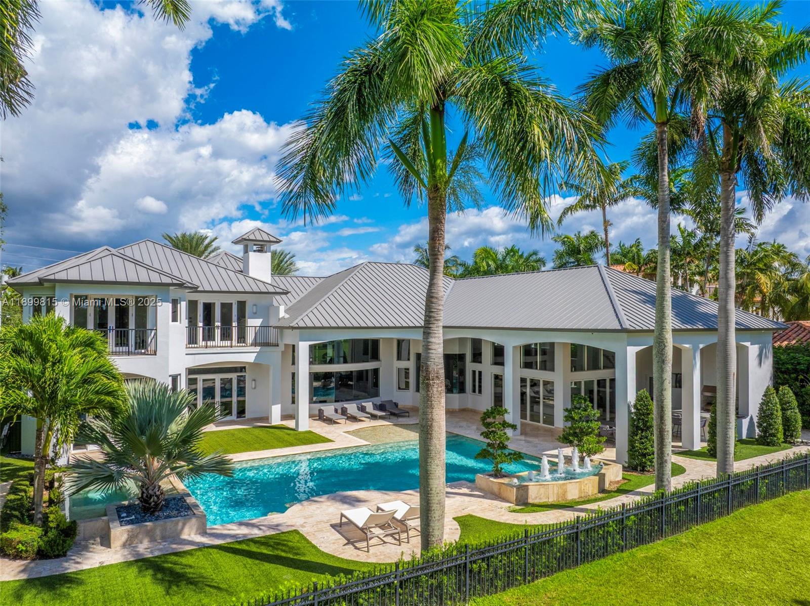 Welcome to the best-positioned residence on Coral Ridge Country Club’s 9th hole, perfectly placed for sweeping views of the fairway and lake. Set on a rare half-acre lot, this 9,000 sq ft estate has been completely reimagined with dramatic ceiling heights, a brand-new chef’s kitchen, and a refined modern design that balances sophistication with warmth. Floor-to-ceiling glass draws the outdoors in, opening to a backyard that feels like your own private resort. Steps from the course and minutes from Fort Lauderdale’s beaches and Pine Crest School, this home embodies the ultimate in golf course living - spacious, stylish, and effortlessly connected to the best of South Florida.