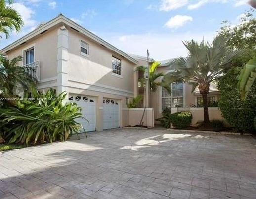 Beautiful home in Grand Palms with high ceilings that allow abundant natural light. Features impact windows and doors, accordion shutters, a new roof under 5 years old, and A/C systems less than 5 years old. Porcelain floors installed 5 years ago, semi-renovated bathrooms, and a modern kitchen with quartz countertops. Elegant staircase with glass railing adds a contemporary touch. The primary bedroom is on the first floor, and the layout provides privacy. Spacious backyard perfect for outdoor activities. A perfect combination of style and functionality