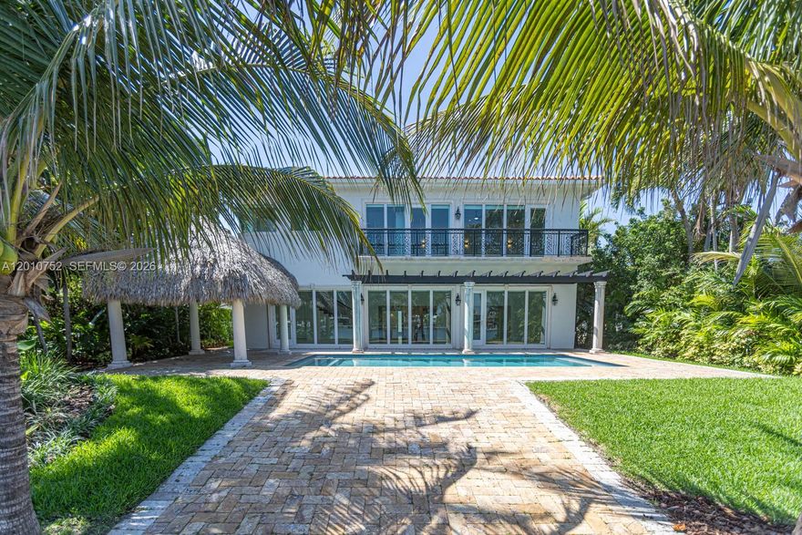 Mediterranean elegance meets Biscayne Bay living. This stunning 2-story waterfront home sits on the exclusive, guard-gated island of Normandy Shores in Miami Beach. Built in 2010 and fully renovated in 2025, this home offers 4,500 SF of refined living on an 11,000 SF lot with 65 FT of water frontage and open bay views.
Soaring ceilings, a chef’s kitchen, marble and Brazilian wood floors, and designer onyx bathrooms set the tone. The primary suite features a private veranda with panoramic water views. Outside, a resort-style pool, dock with boat lift, and two tiki huts complete the picture. Renovated top to bottom. New A/C, updated baths, custom closets, smart electrical, LED lighting, refinished floors, polished marble, motorized blinds, new pool equipment, salt system, irrigation, and fresh landscaping. Nothing was left untouched. Residents enjoy golf, tennis, basketball, clubhouse, and more. Turnkey waterfront living. Move in day one.
