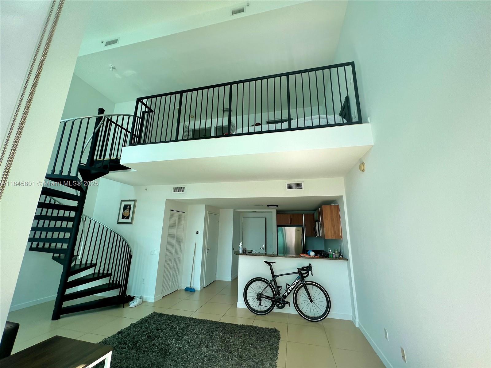 Rare opportunity to lease a two-story loft in Met 1, located in the most coveted loft line of the building—with wider proportions than any other loft line and breathtaking views over Biscayne Bay. Expansive East-facing floor-to-ceiling windows. Dramatic 19'4" ceiling heights. Tile floors throughout. Black out shades in all windows. Striking spiral staircase. Water, basic cable and Internet included. Brand new LifeFitness equipment coming soon. One assigned parking space on the same floor! Walk to Whole Foods Market, Bayfront Park, metro mover, Novikov Bar & Grill Restaurant, Joe and the Juice, Hell's Kitchen restaurant by Gordon Ramsay, plus 17 screens' Silverspot Cinema. Chic downtown living at its best!