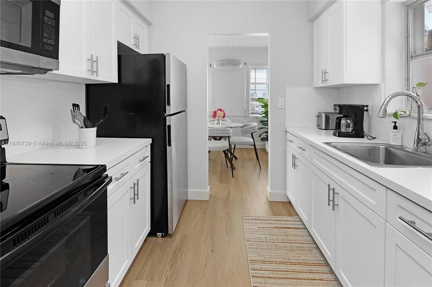 Just steps from the beach, this bright, beautifully renovated 2 bedroom, 2 bathroom home offers the perfect coastal retreat. Filled with natural light, the home features a spacious living room with wood-style floors, creating a warm and inviting atmosphere. The sleek kitchen includes white cabinetry, stainless steel appliances, and plenty of counter space. Enjoy meals in the sunny dining nook surrounded by windows. Both bedrooms are generously sized with ample closet space, and the bathrooms showcase charming retro tile with modern updates. With prime walkable location near shops, cafes, and the ocean, this home blends comfort and style for the ultimate beachside living!