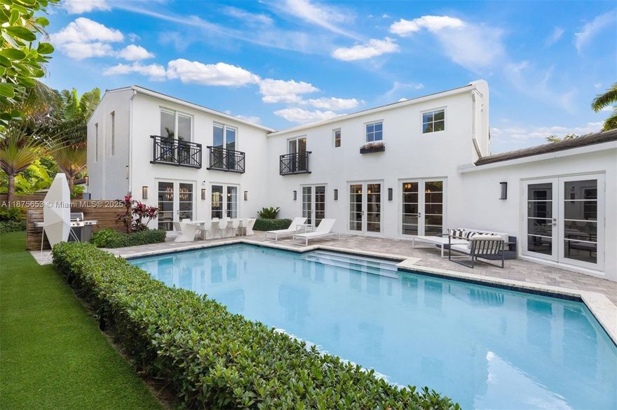 This luxurious Miami Beach estate presents a seamless blend of grandeur and chateau elegance. With 6 beds and 6.5 baths, the open-plan kitchen boasts high-end finishes and top-of-the-line Wolf, Miele, and Subzero appliances. Just steps from the kitchen is a spacious dining area and a relaxing family room. The exquisite master bedroom serves as a private retreat unto itself, featuring a sitting area overlooking the pool and patio. A chic office space, doubling as an ensuite bedroom, offers versatility and convenience. The guest suite impresses with a kitchenette, living area, and stunning lush outdoor views. Conveniently located near upscale restaurants and shops, and a short distance from the ocean, this residence embodies the ultimate Miami Beach lifestyle.