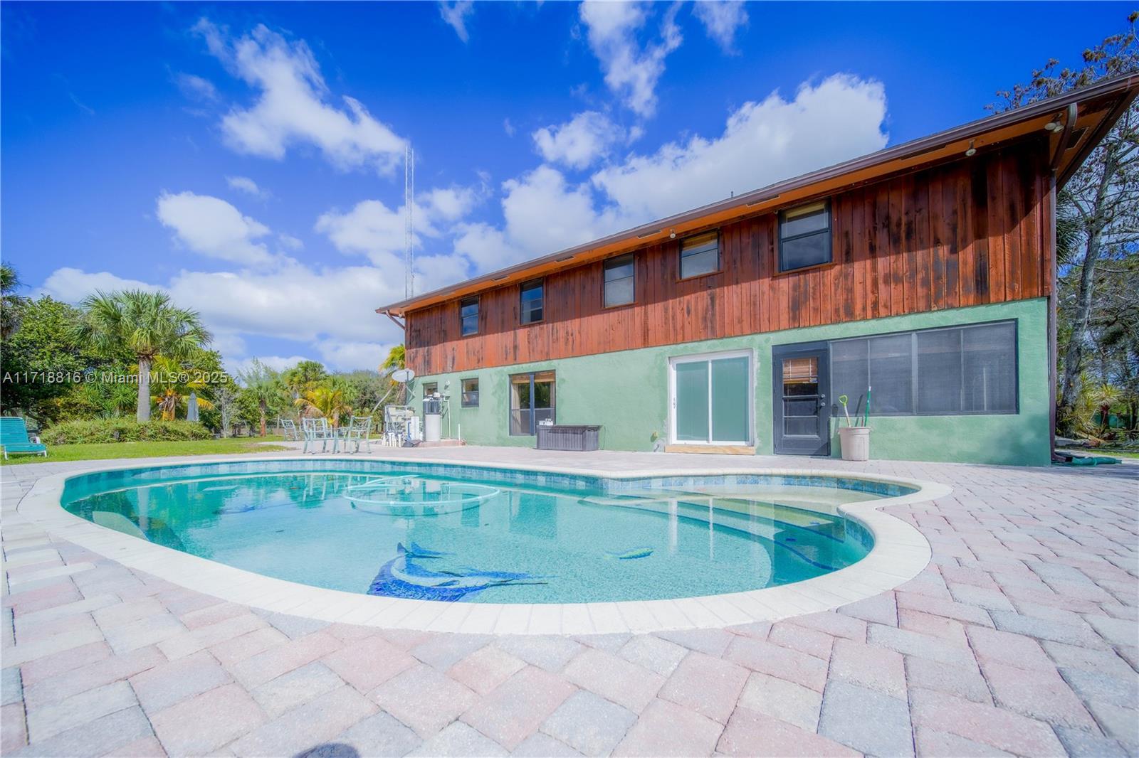 Stunning single-family home in West Palm Beach offering spacious living and breathtaking views. Enjoy abundant natural light throughout, with an open-concept kitchen perfect for entertaining. Relax by the saltwater pool and take in the serene lake views. The expansive patio overlooks the Okeeheelee Nature Center, ensuring privacy with no neighbors behind. Additional features include a spacious open balcony, walk-in closets, and ample storage space. Ideally located just minutes from Florida’s Turnpike, major parks, and shopping plazas. This home is a must-see!