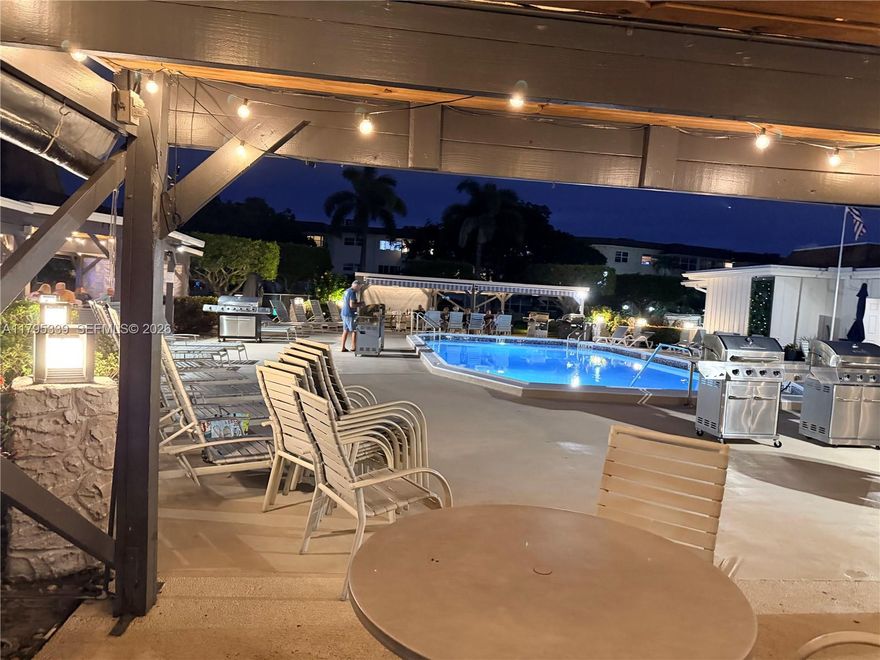 Immaculately maintained first-floor 1-bedroom condo with versatile EXTRA ROOM (ideal for den, hobbies, or office) featuring peaceful lagoon views through windows. Fully furnished & stocked—truly turnkey; just bring your suitcase! Located at 4700 NW 35th St, Lauderhill, FL, in a quiet 55+ community with welcoming tropical vibes. Super convenient: ~20 steps to laundry room & mailboxes; your assigned parking spot directly in front + plenty of visitor parking. Step out to lush grounds with blooming hibiscus, charming walkway bridges over lagoons, and a refreshing heated pool for year-round enjoyment.  Titan electric water heater.  Low monthly maintenance fee covers water, cable, and more—keeping expenses predictable. Association requires no minimum down payment and the unit qualifies for easy financing—making this a smart, accessible opportunity. Don't wait—schedule your private tour today and envision relaxed Florida living!