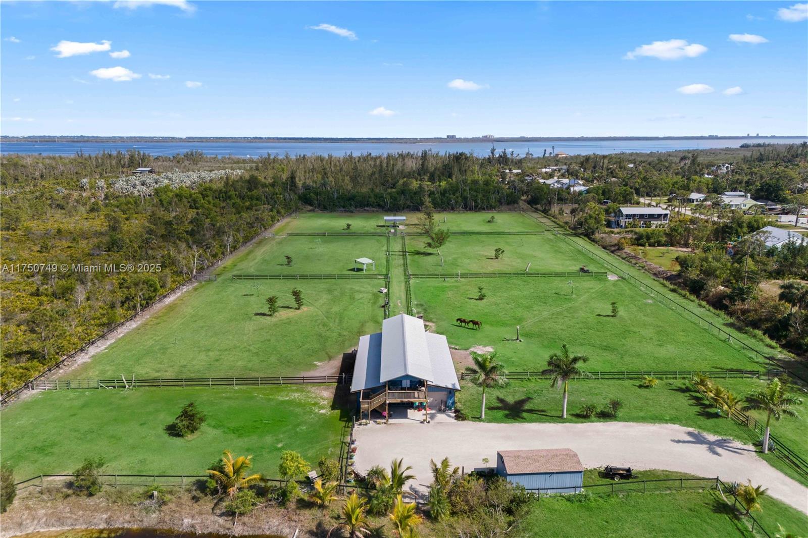 Introducing Moonshine Acres Tropical Horse Farm, an extraordinary equestrian estate that offers an unparalleled sanctuary for both horses and riders. Situated on a private double gated entry off Stringfellow Road, this 8.85 acres of pristine land is the ultimate opportunity to own and grow you own business to include existing boarders and expand to trail rides, training and breeding. This is a completely fenced property that backs to 12 miles of trails that lead directly to the Gulf waters - a paradise for horses. There are 8 expansive and adjoining paddocks, 6 of which are interconnected for uninterrupted movement, plus a dedicated paddock designed for specialized care (a total of nine).