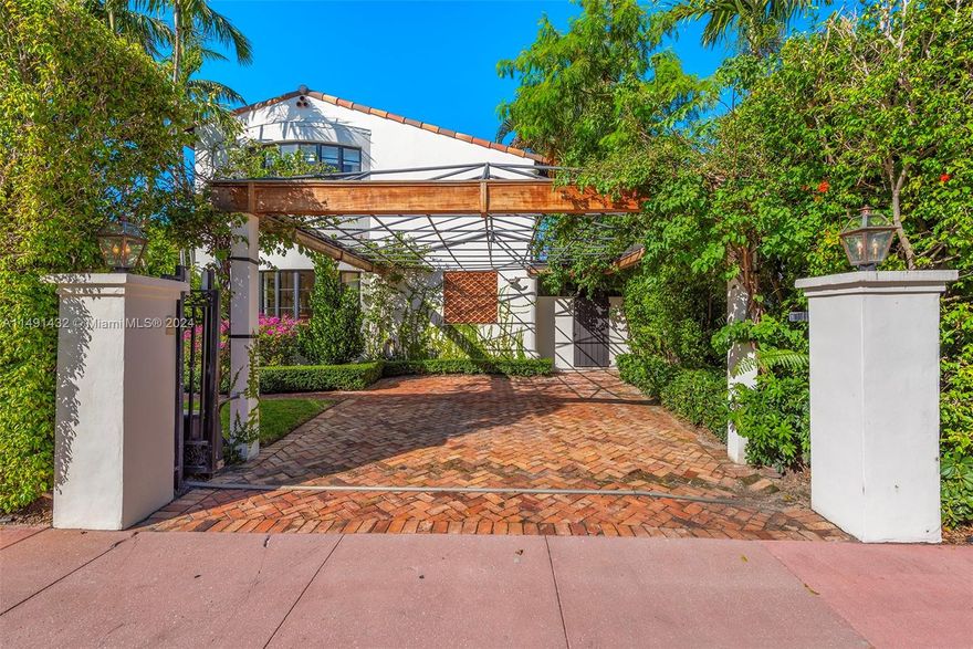 Venetian Islands gem! Behind stately gates, this 2-story Mediterranean home seamlessly blends classic sophistication with modern style. Boasting exquisite details, including rotunda windows, a winding staircase, and a marble fireplace. The chef's kitchen features a Miele stove, a double fridge, and a wine cooler. Enjoy abundant natural light in formal and informal living areas, merging seamlessly through big, beautiful windows. Three bedrooms with en-suite baths offer a perfect retreat. Step into an ultra-private backyard oasis with a covered terrace, oversized pool, and outdoor shower.