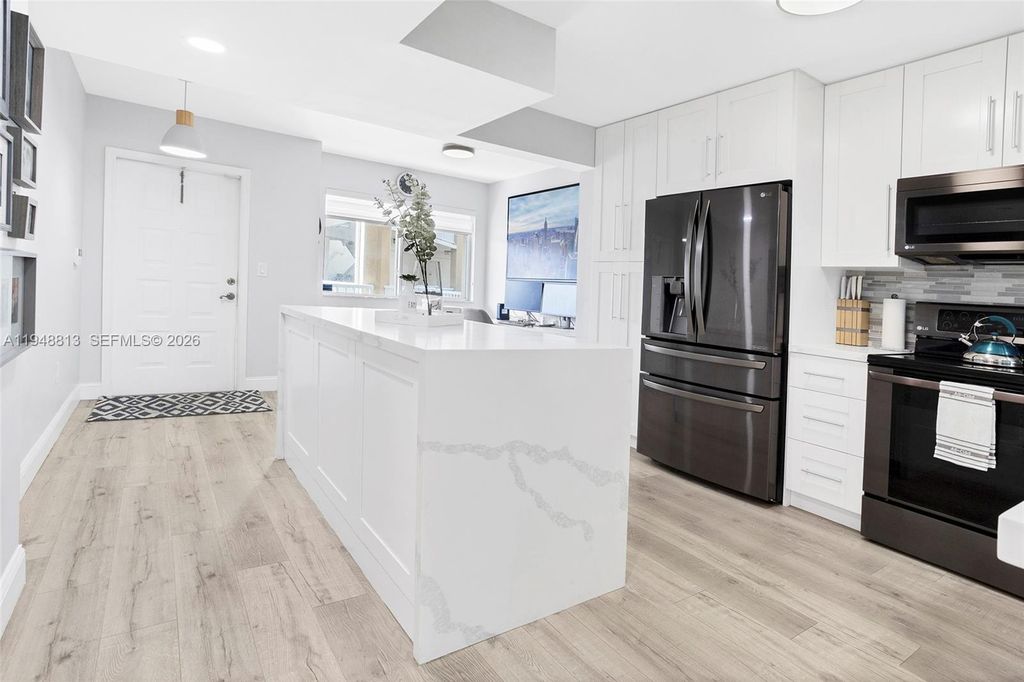 Photo of 7763 Southampton Ter #211, Tamarac, FL 33321 (MLS # A11948813)