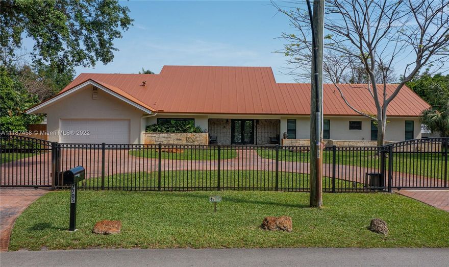 Spectacular, 4 bed, 4 bath, fully updated home located in the heart of Pinecrest. Large master suite with windows on 3 sides, double sinks, shower & jacuzzi. Half acre lot, property is fully fenced with electronic gates and has amazing oak trees. Windows & doors impact. Enormous great room with very high ceiling containing living room on one side of fireplace and formal dining/family on the other both facing pool. Vaulted ceiling has a row of windows along the roof line drenching the home with natural sunlight. Kitchen is renovated containing wood cabinets, granite counters, stainless steel appliances, cooking island with gas range & double wall oven.  Home features a large, covered patio facing the pool, large two car garage & storage shed. Great Palmetto schools.  Checks all the boxes!!!