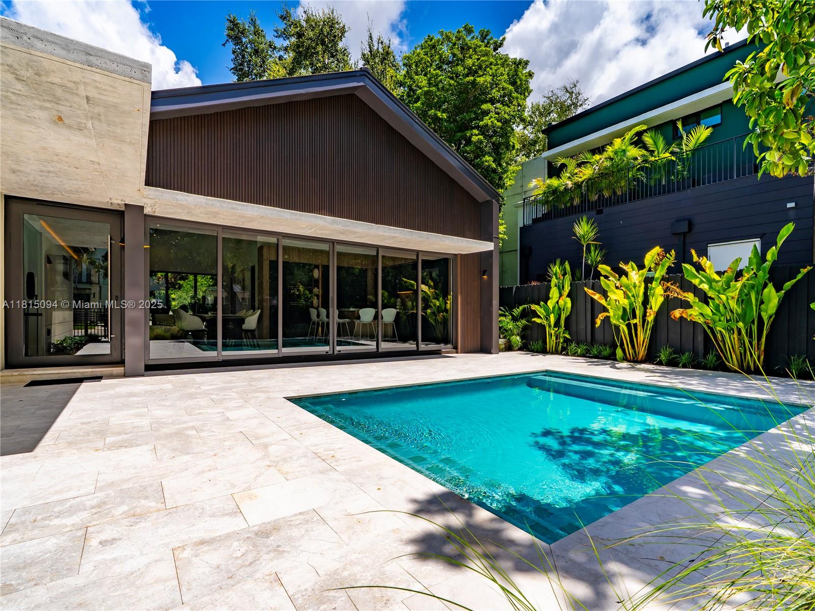 Welcome to 2777 Calusa St. where style, function, and location meet in perfect harmony. Set on a rare 7500 SF triple frontage lot in the heart of Coconut Grove, this 4-bed, 3.5-bath stunner has been completely reimagined from the ground up. Step into an open-concept living space flooded with natural light and anchored by a showpiece European-style kitchen with custom cabinetry and sleek integrated appliances all framed by massive sliding glass doors for that indoor-outdoor Grove vibe. Enjoy high-end touches, porcelain tile floors, full home office, spacious family room & laundry room. Outside, unwind by the stylish pool, host effortlessly with multiple carports & enjoy total privacy. This is not a rebuilt, this is a full reinvention, and it’s one of Coconut Grove’s coolest new offerings!