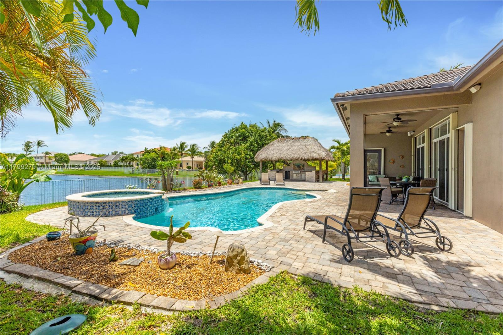 Beautiful 4BD/3BA lakefront home in a gated Cooper City community! Enjoy serene lake views from your private backyard with a full tiki hut & built-in kitchen, perfect for entertaining. This spacious, well-maintained home offers an open layout, updated kitchen, and bright living areas. Located in a quiet, desirable neighborhood, close to parks, top schools, dining, & highways. Don’t miss this rare opportunity to live the ultimate Florida lifestyle! The oversized primary suite offers water views, dual walk-in closets, & a luxurious en-suite bath. Additional highlights include high ceilings, hurricane protection, a 3-car garage, and ample space for families & gatherings. Move-in ready & waiting to impress!