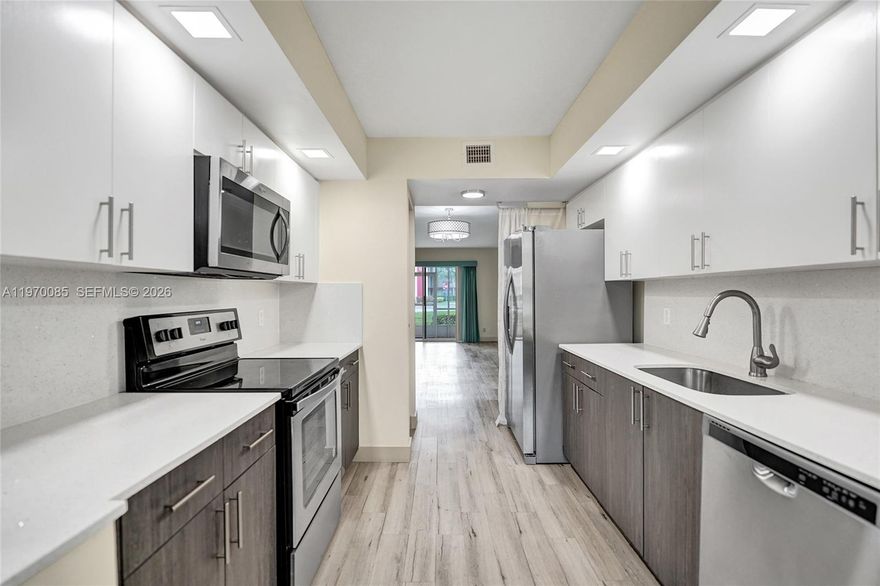 Experience resort-style living in this stunning, 1st-floor Karanda model featuring 1,351 sq. ft. of living space—one of the largest floor plans in Century Village. This unit has been completely remodeled and features modern, wood-look laminate flooring throughout (no carpet!).

The designer kitchen boasts newer cabinetry, sleek Corian countertops, and premium stainless steel appliances. Both spacious bedrooms include large walk-in closets, and the bathrooms have been fully updated with contemporary vanities. For ultimate convenience, a full-size washer and dryer are located inside the unit.

The monthly association fee is all-inclusive, covering water, trash, sewer, and cable TV. Located in a premier 55+ community, residents enjoy a million-dollar clubhouse, two fitness centers, multiple pools, tennis, golf, a theater, on-site pharmacy, and a community bus.