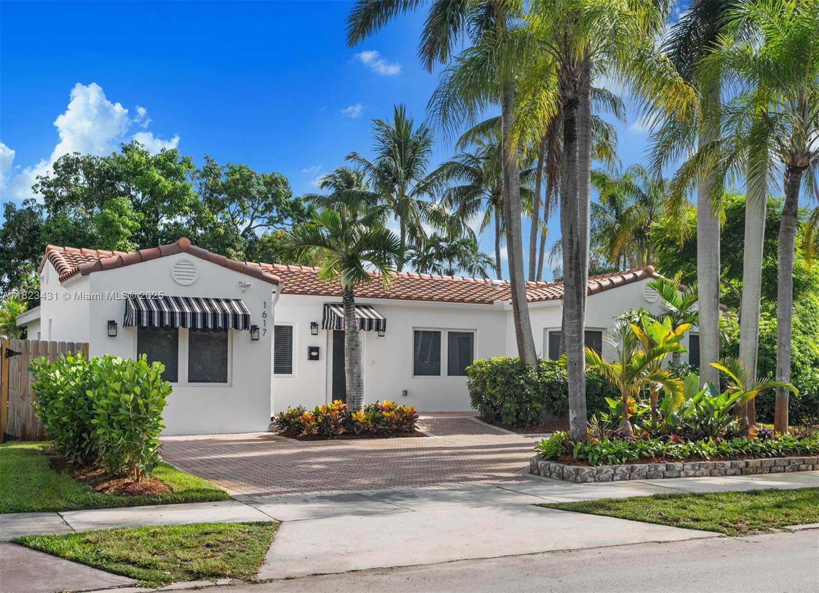 Exuding classic elegance, this newly renovated  4-bed, 4.5 bath residence is nestled on a lushly landscaped lot. Step into a spacious living room w/ vaulted ceiling that seamlessly flows onto an expansive covered patio. The open-concept kitchen features a sleek sitting island w/ quartz countertops. Thoughtfully designed, the home includes: all en suite bedrooms, stylish powder room, separate laundry room, and beautifully appointed modern baths. Porcelain floors run throughout, complemented by refined hardware finishes & upgraded AC vents. Home features brand-new roof, AC & AC ductwork, water heater, new fixtures & appliances as well as new plumbing & electrical systems. Complete impact doors & windows. Transferable termite warranty. Short driving distance to the beach & downtown.