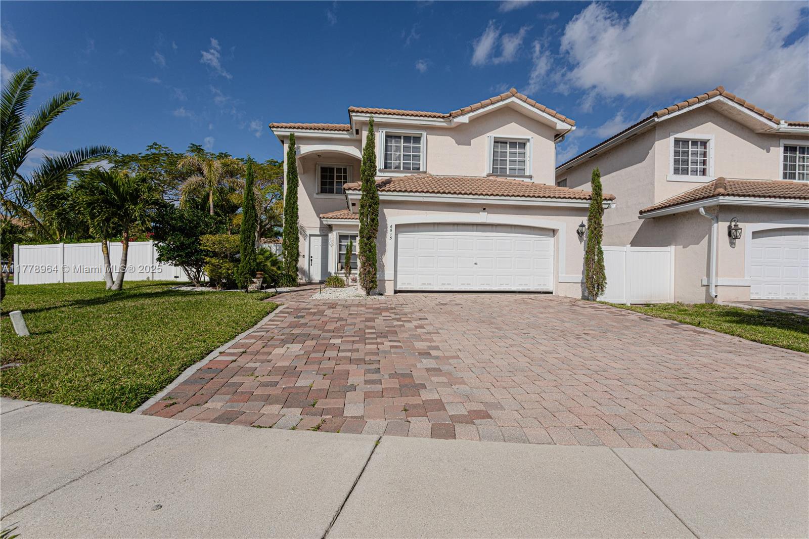 Tour this enchanting 4-bedroom, 2.5-bath estate, centrally located in West Palm Beach, FL. This breathtaking home is warm and inviting, an ideal space for family and friends. Enjoy the open concept and contemporary design with white porcelain tile downstairs and in all bathrooms. The newly renovated kitchen with crisp, sleek white cabinets, an oversized peninsula, and quartz countertops will keep you captivated by this house. The grand master suite has the well sought-after his and hers closets and an immense en suite not even seen in some larger homes. Plenty of room for your large family with a second master bedroom upstairs and a second bathroom with double sinks. You will be captivated by the huge lot size and lush landscaping with mature trees.