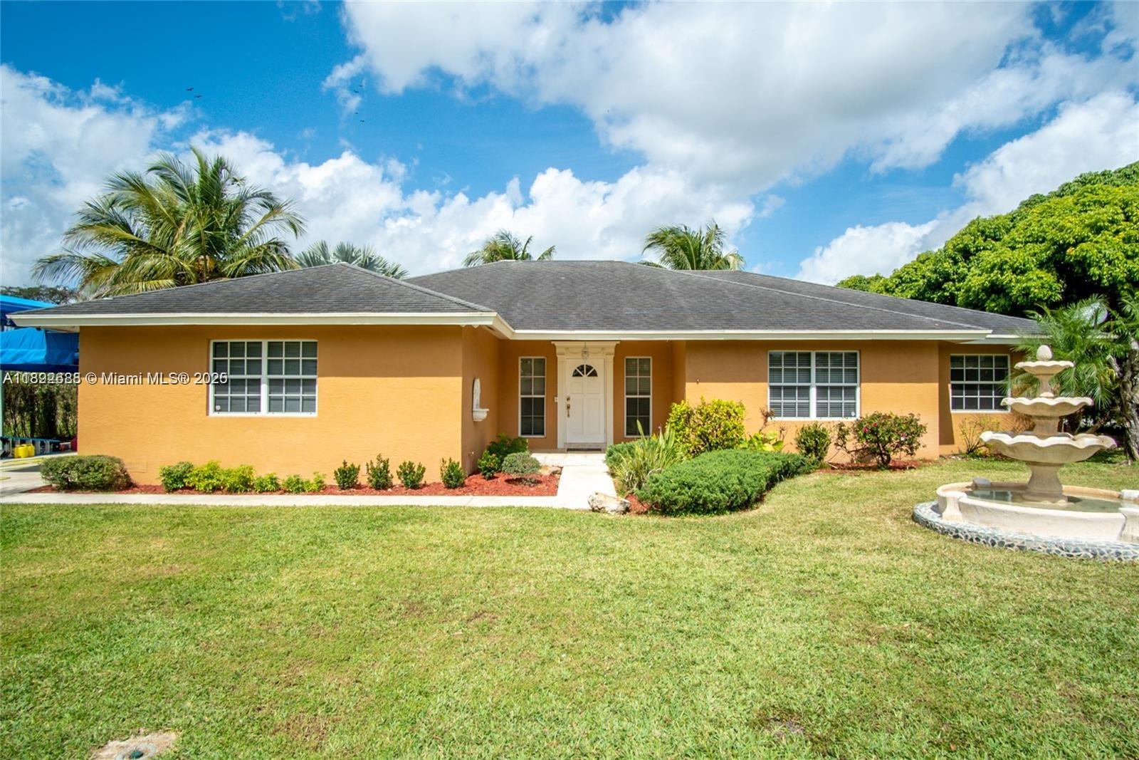 Welcome to your Redland oasis! This spacious 3-bedroom, 2-bath single-family home sits on nearly three-quarters of an acre in a lush, private setting. Beautiful fruit trees surround your yard, and the centerpiece is a sparkling pool with a charming tiki hut — ideal for summer entertaining. Inside, enjoy warm wood floors in the bedrooms and modern tile throughout the living areas, plus updated stainless steel appliances and recessed lighting. Oversized French doors open to the pool terrace, blending indoor and outdoor living beautifully. With a two-car garage and covered space for an RV or boat, this home combines comfort, style, and functionality. A true must-see.