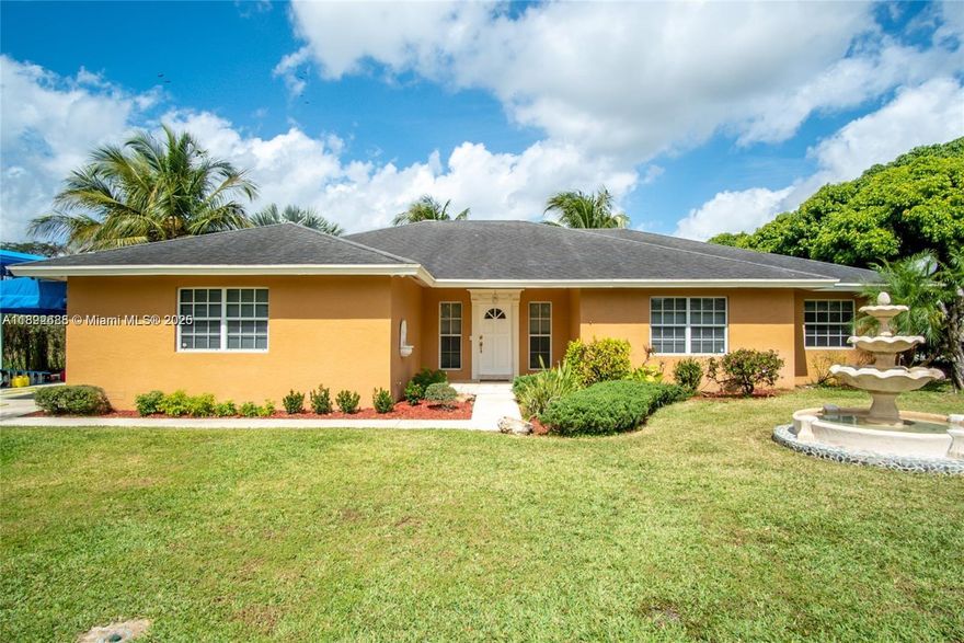 Welcome to your Redland oasis! This spacious 3-bedroom, 2-bath single-family home sits on nearly three-quarters of an acre in a lush, private setting. Beautiful fruit trees surround your yard, and the centerpiece is a sparkling pool with a charming tiki hut — ideal for summer entertaining. Inside, enjoy warm wood floors in the bedrooms and modern tile throughout the living areas, plus updated stainless steel appliances and recessed lighting. Oversized French doors open to the pool terrace, blending indoor and outdoor living beautifully. With a two-car garage and covered space for an RV or boat, this home combines comfort, style, and functionality. A true must-see.