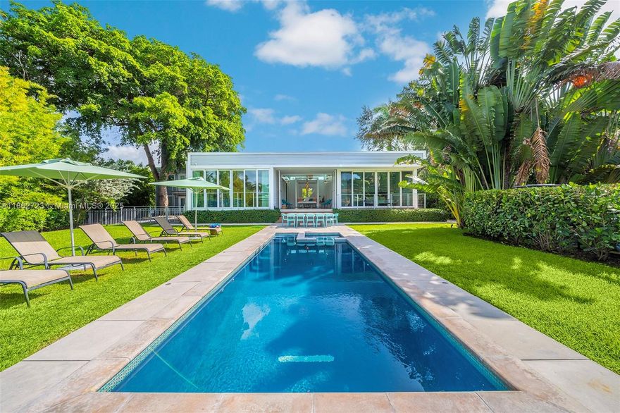 Villa Tulum is a waterfront retreat in Miami’s sought-after Upper East Side, where modern comfort blends with a
tropical lifestyle. Located on an 11,000 sq.ft. lot, this 2017-built estate is designed for seamless indoor-outdoor
living. The main residence offers an airy open-plan living and dining area, sleek kitchen, 4 bedrooms, and a breezy covered patio. A detached two-story guest house includes a 2-bedroom loft with kitchen and bath+maid’s quarters and storage. Outdoors, lush gardens surround an infinity pool overlooking the Miami River, complemented by a new private dock for boats up to 65 feet with direct access to the bay. Ready to move in, this property is perfect for those seeking a tranquil primary home, a vacation escape, or a smart investment in a rapidly growing neighborhood.