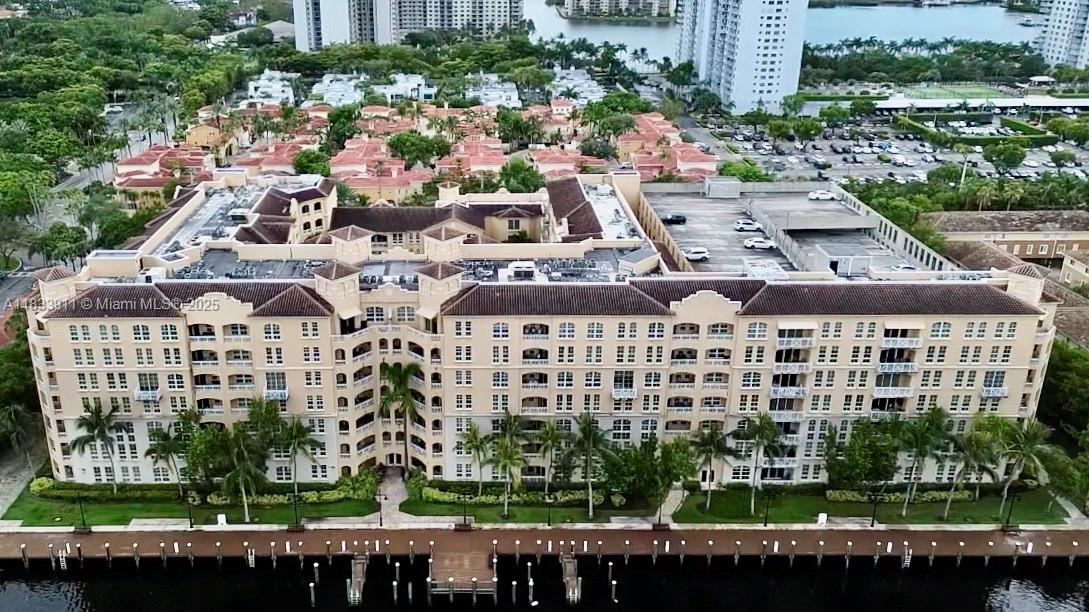 Remodeled corner unit with no side neighbors and soaring ceilings—this rare 1st-floor Alaqua condo offers privacy, elegance, and unmatched location. Enjoy 2 assigned covered parking spaces, an open kitchen with granite countertops and stainless steel appliances, in-unit washer/dryer, and a spacious 2/2 split layout. High ceilings and abundant natural light flow throughout. Luxury amenities include waterfront gym, pool, clubhouse, business center, and 24/7 security. Just 5 minutes from Aventura Mall, top-rated A+ schools, dining, and the marina. Pet-friendly, gated community with charm and comfort. Virtual tour available! Please call Co Listing Agent Ricardo Jimenez for showings. 786-301-0336