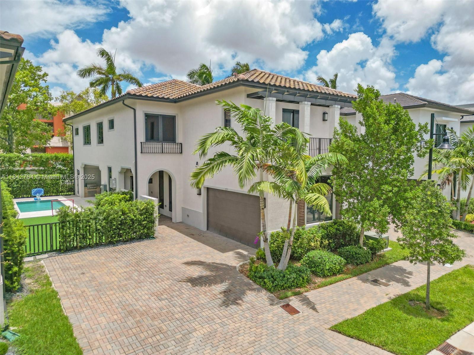 Step into luxury in this exquisite 4-bed, 4-bath residence with a 2-car garage, located in the prestigious Canarias community of Downtown Doral. This elegant home features high ceilings and expansive living spaces that open to a private backyard oasis with a custom pool. The kitchen is equipped with top-of-the-line Sub-Zero and Wolf appliances, a striking waterfall-edge quartz island, and premium finishes throughout.
Enjoy a spa-like bathroom boasting dual floating vanities and an oversized glass-enclosed shower with soaking tub. Outdoors, the covered terrace and summer kitchen provide the perfect setting for entertaining or relaxing. Amenities including a resort-style pool, fitness center, indoor basketball, billiards room, and more. located near top-rated schools, dining, and shopping.
