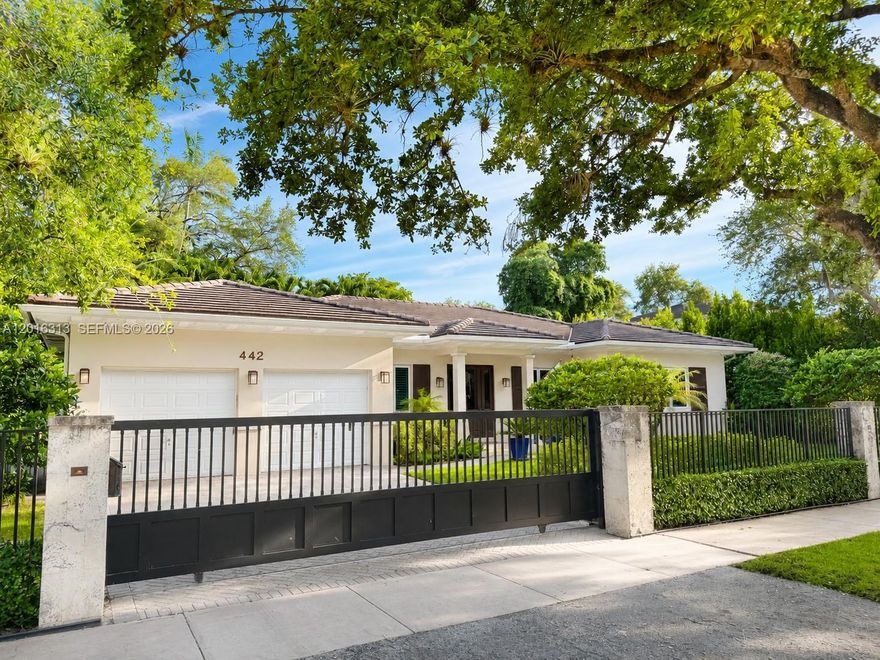 Magnificent contemporary-modern custom home in South Gables, beautifully designed. Electric gates welcome you into a warm and inviting residence featuring spectacular wood volume ceilings, limestone architectural accents, impact windows and doors, and refined finishes throughout. Built in 2010 with exceptional quality appointments, the open and flowing floor plan offers the perfect balance of elegant entertaining spaces and private living areas. This upscale residence features 3 spacious bedrooms, 3 full baths, a 2-car garage, state-of-the-art audio system, solid wood 8-foot interior doors, stunning custom millwork, plantation shutters throughout the interior, and decorative plantation shutters enhancing the exterior charm. The generous primary suite offers beautiful custom cabinetry and a luxurious atmosphere designed for comfort and relaxation. Outdoor living is exceptional with a covered patio, sparkling pool, and summer kitchen complete with stainless steel appliances, ideal for entertaining family and friends year-round. Numerous recent upgrades include two new air conditioning systems, new pool pump and filtration system, new pool heater, 120-gallon propane tank, Tesla solar panels with backup batteries that function like a generator, and a new drinking-water filtration system. Centrally located, commuter-friendly, impeccably maintained, and offering both style and functionality, this pristine South Gables home is truly a rare opportunity for the most discerning buyer.