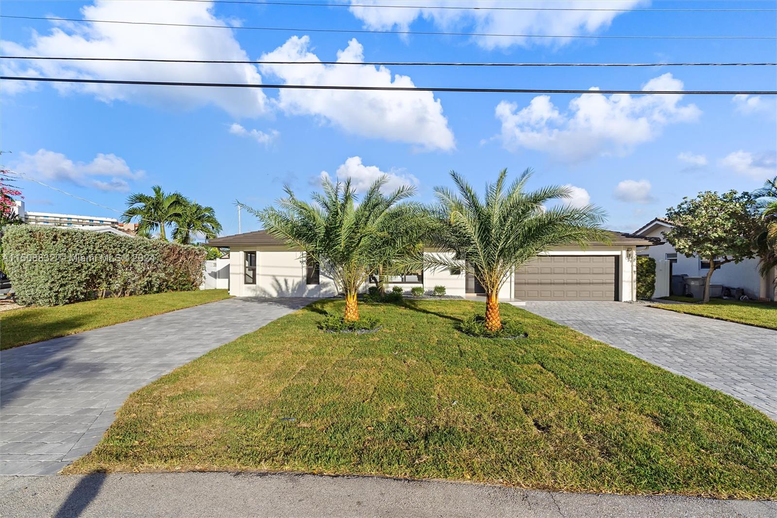 This masterfully remodeled home elevates the modern residential aesthetic with an artful, organic design that’s both dazzling and functional. A masterpiece of modern design, located in a prime spot with direct Intracoastal Access and NO fixed bridges, making it a dream for boaters. With 80' of waterfront and an updated seawall, you'll reach the Hillsboro Inlet from your dock in 10 minutes! The remodel includes new impact windows, a refurbished pool with marble pavers, a high-efficiency Carrier AC, tankless water heater, wine cooler, Samsung appliances, custom oak cabinets, double master vanity, double shower head, cascade faucets, 2 walk-in closets, and a 2-car garage. Only a 5-minute drive (or 15-minute walk) to the newly renovated Pompano Beach Pier. Low taxes and No HOA!! East of US1!