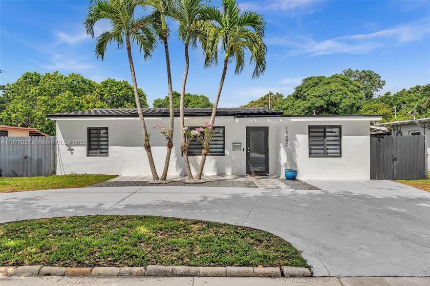 Step into this exquisitely remodeled 4-bedroom, 3-full-bath modern home, where luxury, functionality, and design come together in perfect harmony. With a stunning chef’s kitchen featuring sleek white quartz countertops, custom two-tone cabinetry in warm wood and high-gloss white, and state-of-the-art appliances, including a statement-making matte refrigerator. A spacious island with seating invites casual meals and conversation, while the clean lines and minimalist hardware add a distinctly contemporary touch. The open-concept living area is bathed in natural light, seamlessly blending indoor comfort with outdoor serenity through large all-glass Impact windows and sliding doors that lead to a private all-fenced backyard oasis. Schedule your showing today!