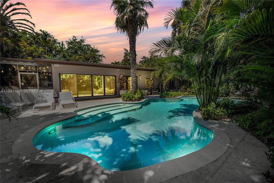 Quintessential charming South Grove gem nestled on a tree canopied cul-de-sac. Enter into a captivating tropical garden that embraces the home, 42 FT lagoon style pool and inviting outdoor spaces. Enjoy the sunlit living room, dining room and glass roof screened patio for the ultimate Florida indoor/outdoor lifestyle. In addition to the 3 bedrooms there is a flex space for a 4th bedroom, office or gym. Special features include an expansive 10,400 FT lot, privacy wall, remodeled kitchen and bathroom, fire pit, vegetable garden and impact windows/doors. Close to top-tier schools, marinas and restaurants.