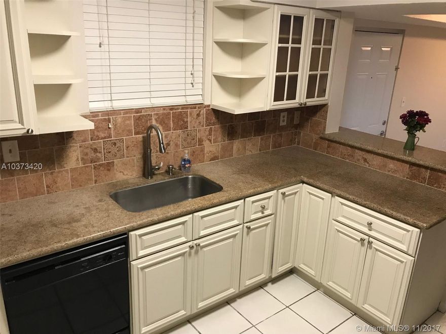 Best priced one story 3 Bedroom opportunity in West Kendall. Recently remodeled unit.  Large walk in Kitchen with Granite counters and built in lazy Susan in cabinetry.  Washer/Dryer in the unit.  Titan Instant water heater.  Jacuzzi tub.  Built out Closets.  Title throughout. Balcony. Gated Community.  Pool & Assigned Parking.