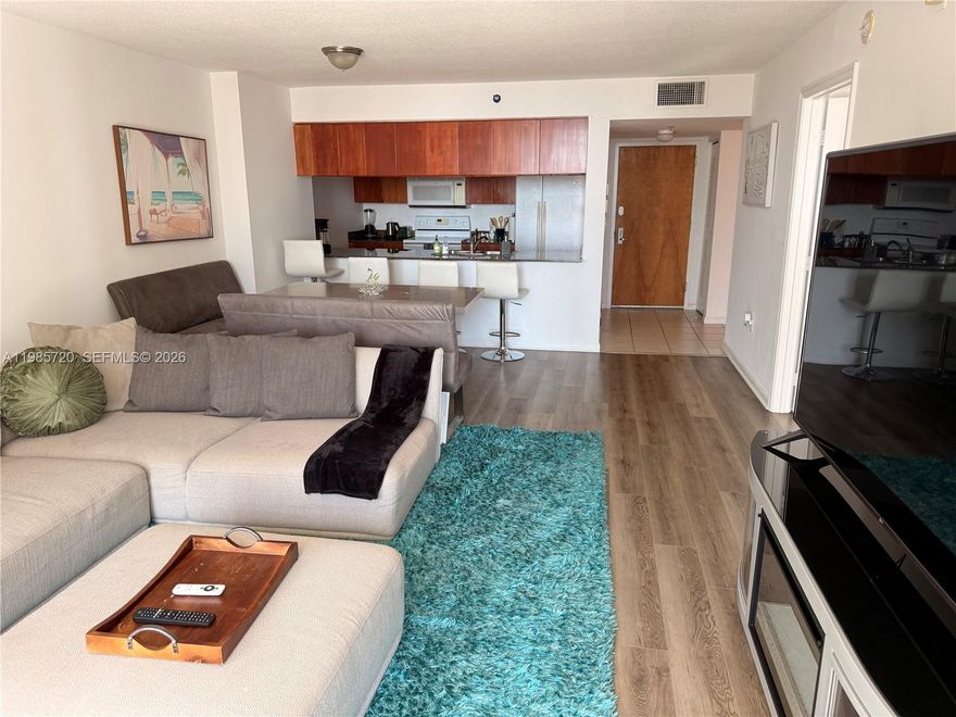 Spacious and bright 1-bedroom condo (over 825 sq ft) on a high floor with amazing water and city views at The Club at Brickell Bay. This clean, well-maintained residence features newer wood flooring (no carpet), a new in-unit washer and dryer, and a generous layout with plenty of space for large furniture. Enjoy beautiful southern views of Biscayne Bay from the living room, bedroom, and oversized balcony, with abundant natural light throughout. The bedroom offers excellent storage with two walk-in closets. The galley-style kitchen includes granite countertops, dishwasher, microwave, and abundant cabinet space. Resort-style building amenities include two bayfront pools, jacuzzi, modern fully equipped fitness center, theater room, club room for events, additional laundry facilities with vending machines, one assigned parking space, and 24-hour front desk security.