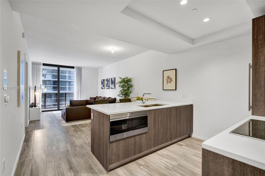 SLS Lux 1 Bed + Den, 2 Full Baths. Features porcelain wood-look floors, Nest A/C system, and premium Wolf appliances. Enjoy top-tier amenities including a rooftop pool, tennis court, private elevator, and more. Prime location near shops, restaurants, and entertainment.