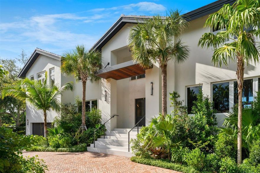 Located in the gated Sunrise Harbor community, this completely renovated waterfront contemporary estate offers 7,435 total SF on a 14,500 SF lot with 100 feet of canal frontage and no bridges to Biscayne Bay. The 6-bedroom, 6 full and 1 half-bath home showcases a dramatic triple-height living room, panoramic water views, custom millwork, Lutron smart lighting, and high-impact glass throughout. A chef’s kitchen features bespoke cabinetry, leather finish marble countertops, Sub-Zero and Miele appliances, and glass-enclosed cabinets. The expansive primary suite includes vaulted ceilings, a private balcony, and a spa-like bath. Newly added flex and wellness spaces open up right onto the backyard with ample windows/natural light, including a bedroom/gym, cabana bath, steam shower, sauna, cold plunge and separate HVAC. Outdoors, enjoy lush landscaping, a circular driveway, heated saltwater pool with spa, expansive terraces, summer kitchen, glass railings, and a concrete dock with deep water docking for large boats/yachts—perfect for seamless indoor-outdoor waterfront living near top schools, Coconut Grove, and Coral Gables.