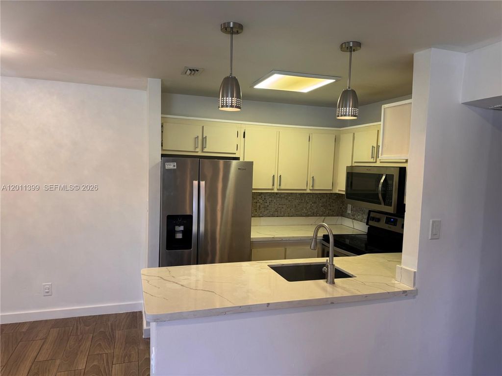 Photo of 10023 Winding Lake Rd #204, Sunrise, FL 33351 (MLS # A12011399)