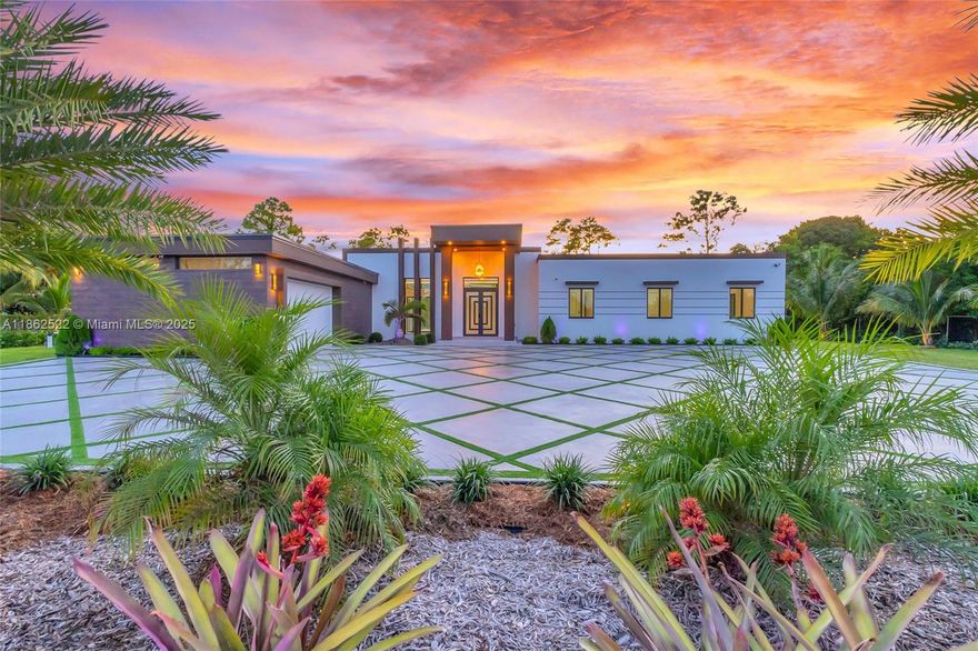Discover unparalleled luxury in this brand-new custom estate with exquisite finishes. This expansive single-level home offers 4 bedrooms, 3.5 bathrooms, a spacious laundry room, and a chef’s kitchen with sleek cabinetry, premium appliances, and a marble waterfall island. The open-concept layout boasts soaring ceilings and modern design. The owner’s suite features a spa-inspired bath with freestanding tub, rainfall shower, and custom walk-in closet, while a second master with private bath adds flexibility. Set on 1.2 acres, the outdoor oasis showcases a saltwater pool, Jacuzzi, and terrace with fans and speakers. A gated entrance, 2-car garage, and parking for 20 complete this private retreat, minutes from Black Point Marina and Biscayne National Park.