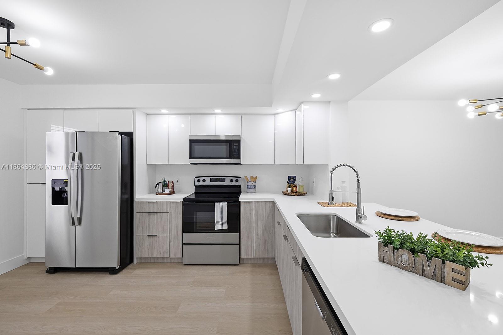 Welcome to this beautifully updated 2/2 unit w/a serene golf view that greets you as you enter the front door. oasts a contemporary kitchen with sleek, ceiling-high cabinets, quartz countertops, and brand-new appliances. Enjoy the beauty of brand-new vinyl flooring, freshly painted interiors, and elegant, bathrooms. Breathtaking views. Enjoy the convenience of an in-unit washer and dryer. The HOA is $512/month plus CVP $266/month, and includes water, cable, internet, and access to endless amenities, including a million-dollar clubhouse. Located in Buckingham East I at Century Village, one of Pembroke Pines most desirable 55+active adult communities—minutes from The Shops at Pembroke Gardens and major highways. Parking #31N