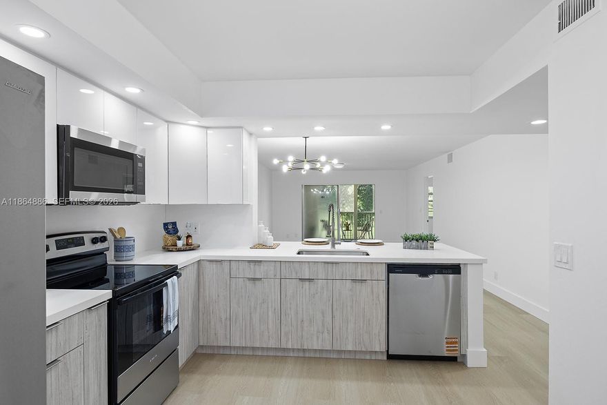 Welcome to this beautifully updated 2/2 unit w/a serene golf view that greets you as you enter the front door. oasts a contemporary kitchen with sleek, ceiling-high cabinets, quartz countertops, and brand-new appliances. Enjoy the beauty of brand-new vinyl flooring, freshly painted interiors, and elegant, bathrooms. Breathtaking views. Enjoy the convenience of an in-unit washer and dryer. The HOA is $512/month plus CVP $266/month, and includes water, cable, internet, and access to endless amenities, including a million-dollar clubhouse. Located in Buckingham East I at Century Village, one of Pembroke Pines most desirable 55+active adult communities—minutes from The Shops at Pembroke Gardens and major highways. Parking #31N