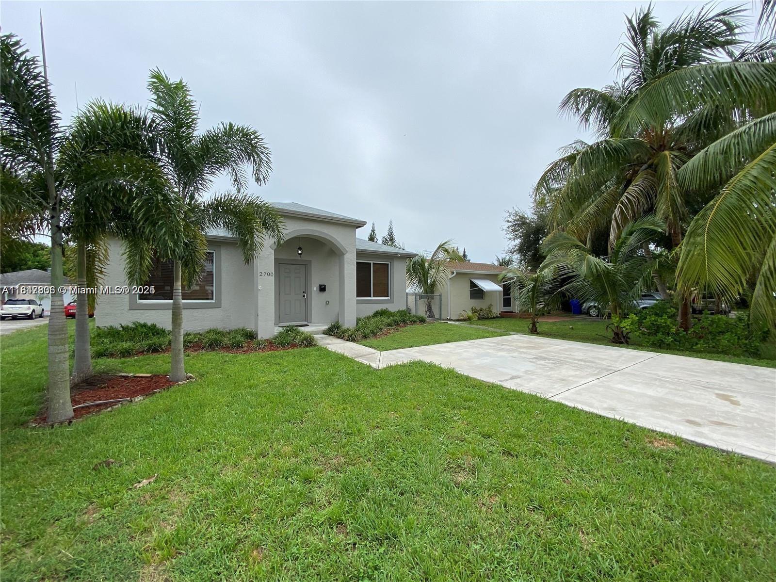 Discover this stunning, spacious 2017-built home with high ceilings and expansive yards, ideally located near Hollywood Circles. This 3-bedroom, 2-bathroom beauty boasts a contemporary kitchen with white cabinets, black granite countertops, and stainless steel appliances. Enjoy tile flooring throughout, hurricane impact windows, full insulation, and a tankless water heater for energy efficiency. The property features a large fenced backyard with mature trees and generous front yards with plenty of parking, providing ample space for relaxation and outdoor fun. This charming home offers the perfect blend of comfort and convenience in a prime Hollywood location.