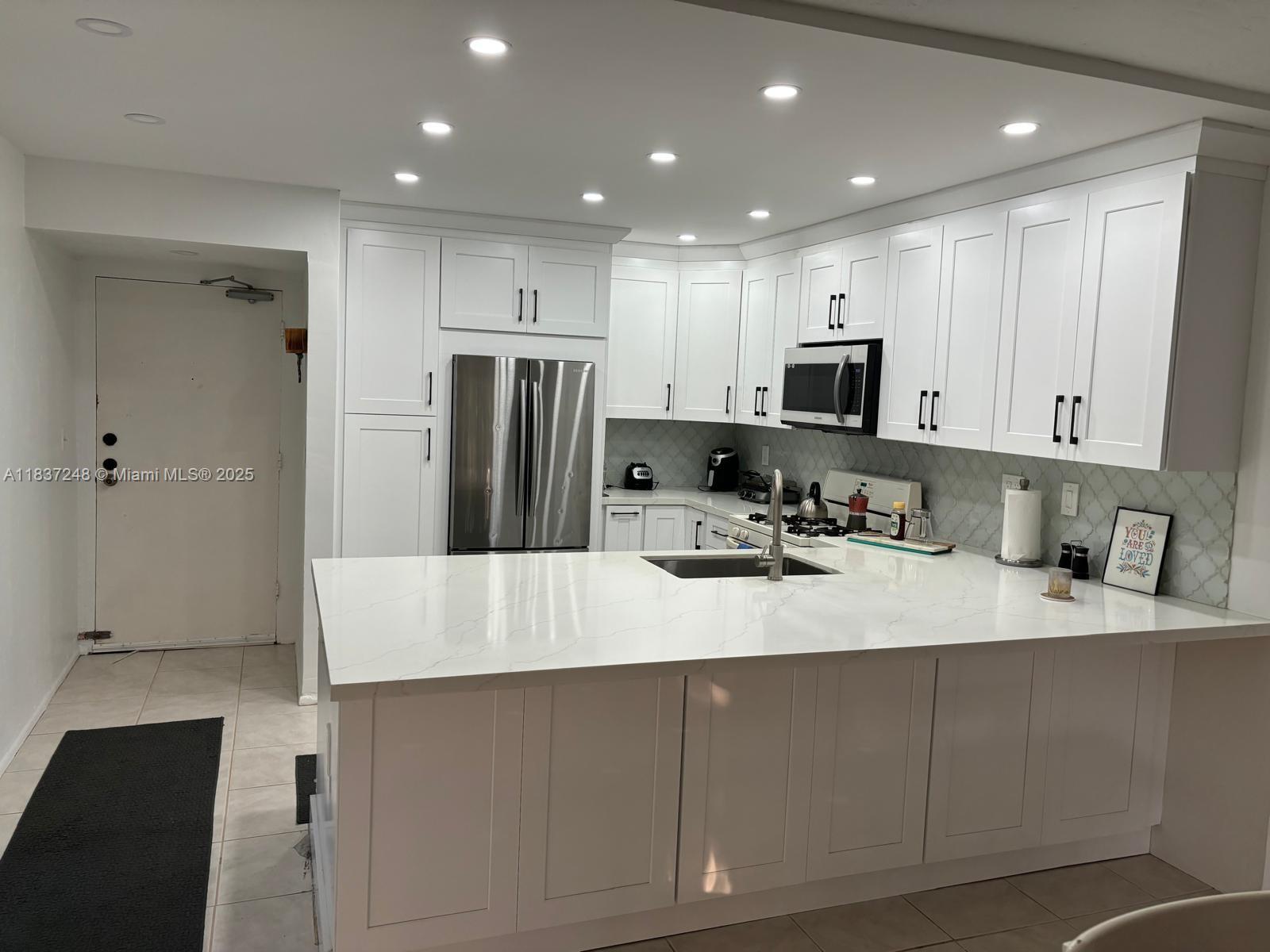 PINECREST: Spacious 2-bedroom, 2-bath apartment east of U.S. 1, within walking distance to Metro Rail, Downtown Dadeland, Dadeland Mall, Trader Joe's, and area restaurants and cafes. The kitchen is fully remodeled with new appliances and updated bathrooms. Beautiful, private, and quiet gated community with overnight security. The outdoor area features lush landscaping, 2 pools, a hot tub, and BBQ grills. Designated parking for one vehicle and access to top-rated Pinecrest schools.
