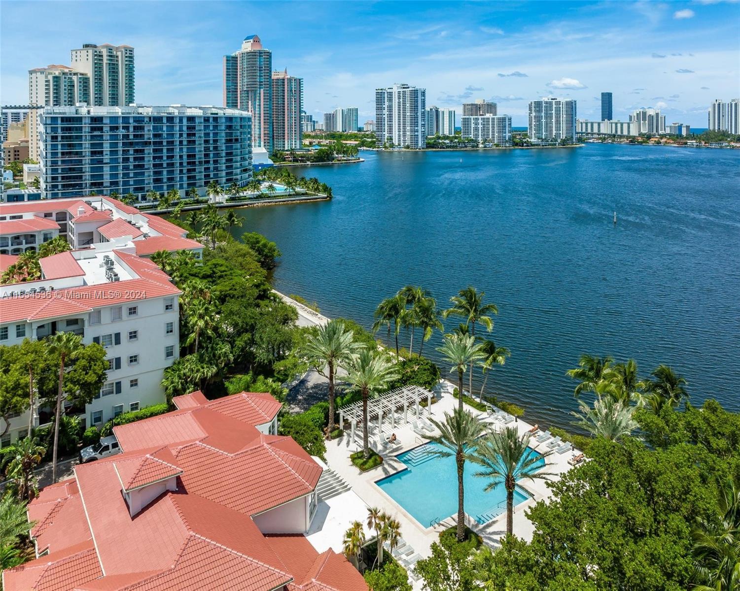Enjoy resort-style living at Village by the Bay! Come tour this 2 bedroom mediterranean-style condo offering direct pool views from the east-facing balcony. Unit is on the 2nd floor, same level as the parking area, no stairs or elevator needed! Modern comforts include: full-size washer/dryer, newer AC & water heater, and walk-in closet. Village by the Bay is a well-maintained, 24 hour guard-gated community featuring: 2 sparkling pools, hot tub, BBQ areas, walking paths, tennis courts, a theater, yoga studio, gym & dog park. Perfect for investors, this property allows for immediate rental with a 31-day minimum lease. Convenient to all that Aventura has to offer, including playgrounds, A+ schools, Fresh Market, Starbucks, Aventura Mall, Brightline & a host of dining and shopping options.