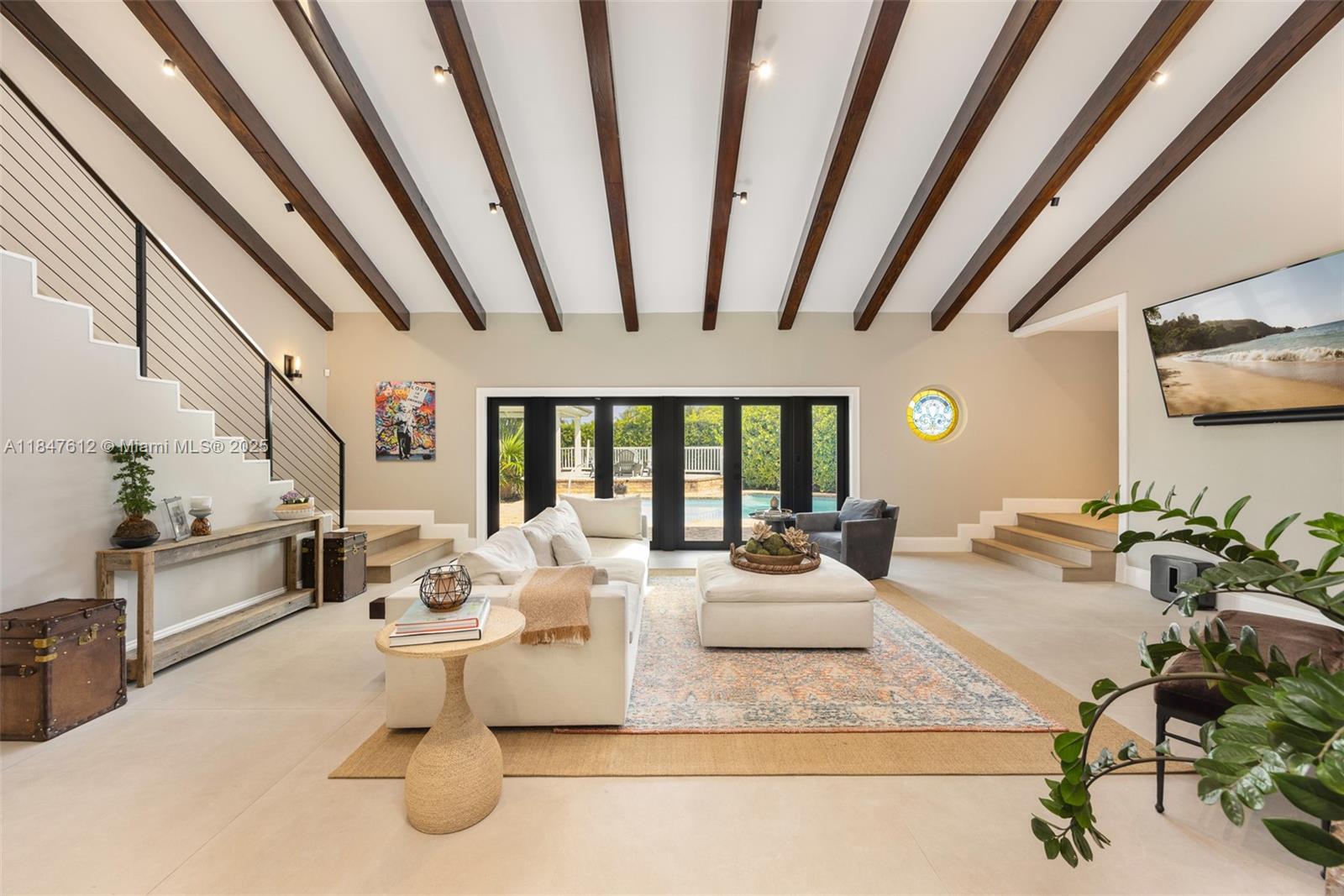 This stunning modern farmhouse offers a rare blend of character, comfort, and style in North Palmetto Bay. Nestled on a quiet, tree-lined cul-de-sac, this thoughtfully renovated 5-bed, 4-bath home features vaulted ceilings, a split floor plan, and elegant porcelain and wood floors throughout. The warm, inviting layout is anchored by a chef’s kitchen with quartz countertops, a spacious island, premium appliances, and a 48-inch gas range. The well-appointed primary suite includes a spa-like bath, large walk-in closet, and a private office-perfect for working from home or unwinding in peace. Outside, enjoy a fenced backyard oasis with mature trees, a covered gazebo, and a pool framed in timeless Chicago brick. One-of-a-kind for South Florida living.