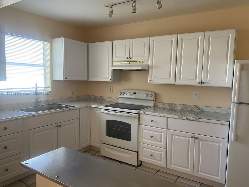 Photo of 10772 La Placida Dr #7-301, Coral Springs, FL 33065 (MLS # A11873424)