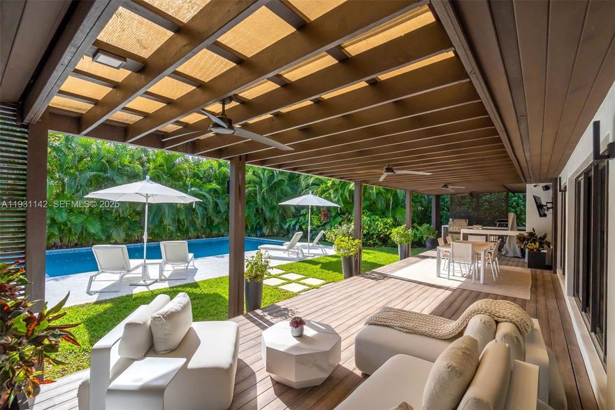 Live in one of the most beautiful corner residences in the heart of Miami Shores, offering approximately 3,100 SQFT of living area on an oversized 13,500 SQFT lot. This exceptional 4-bedroom, 3.5-bathroom home showcases refined design with thoughtfully curated finishes and meticulous attention to detail. Elegant porcelain floors and a bright, open-concept layout create an ideal setting for both everyday living and entertaining, while the kitchen is outfitted with premium appliances. The spacious primary suite overlooks the backyard oasis and features an oversized walk-in closet. One bedroom is currently configured as a private gym/spa, adding a wellness-inspired element to the home. Additional upgrades include hurricane-impact windows, updated electrical and plumbing systems, a fully permitted septic tank with the City of Miami Shores, and an automatic driveway gate for added convenience and security. The outdoor space is a true highlight, featuring a heated saltwater pool surrounded by fully grown, lush tropical landscaping that creates exceptional privacy and a serene, resort-style atmosphere. Mature greenery, manicured grounds, and thoughtful landscape design transform the backyard into a peaceful retreat perfect for relaxation.